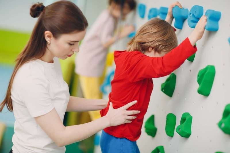 A child on a climbing wall
