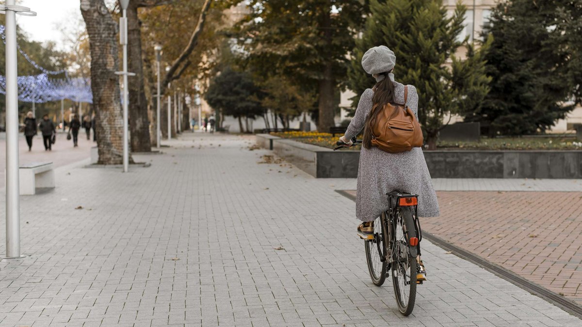 A woman is riding a bicycle