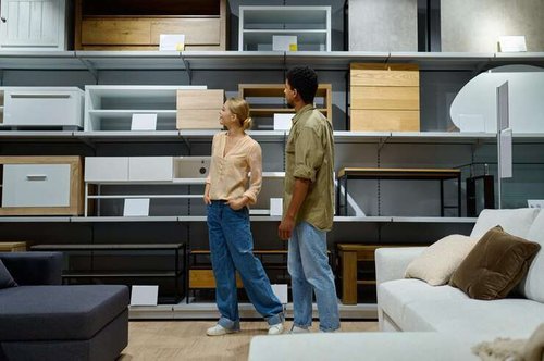 A young couple in a store choosing IKEA furniture