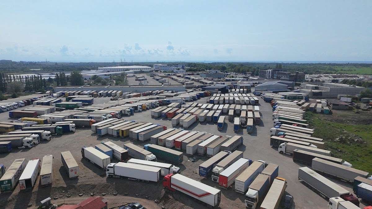 Hundreds of parked freight trucks and trailers packed into a large lot near the coast at the Sarpi border checkpoint.