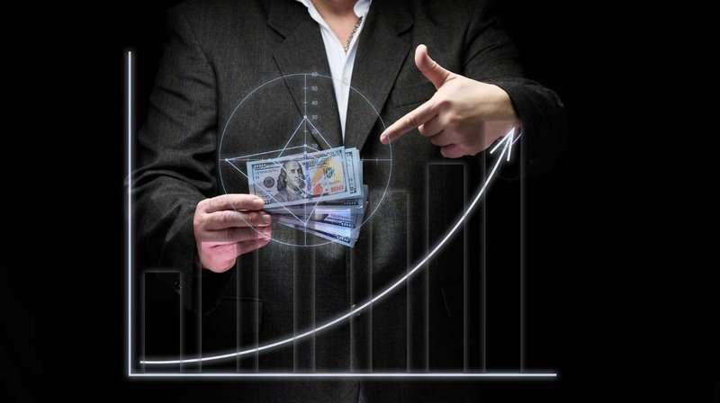 A businessman in a suit holding dollars in his hands is a concept for increasing sales through local promotion.