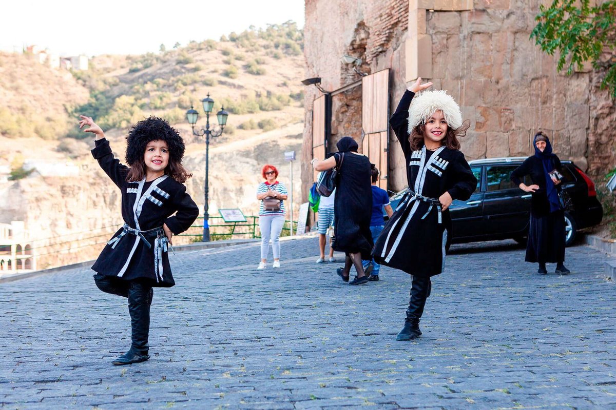 Children in Georgian costumes perform folk dances.