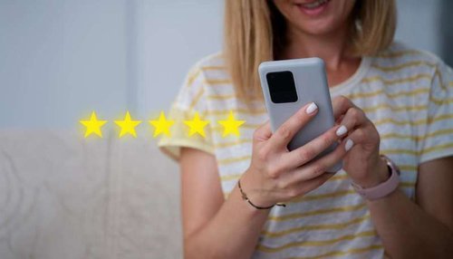 A girl with a mobile phone in her hands and a five-star rating