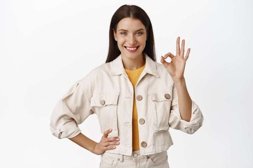A young brunette shows her hands in approval