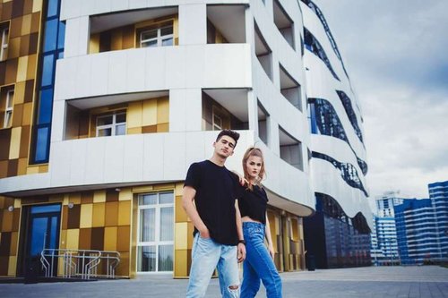 A young couple near a residential complex
