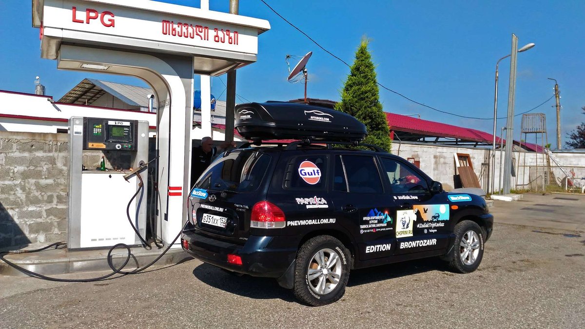 The car is filled with gas at a gas station