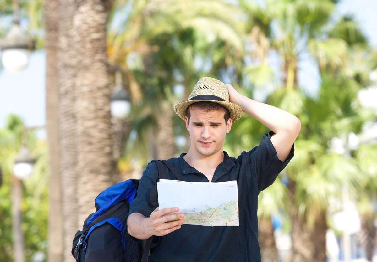 A tourist studies a map