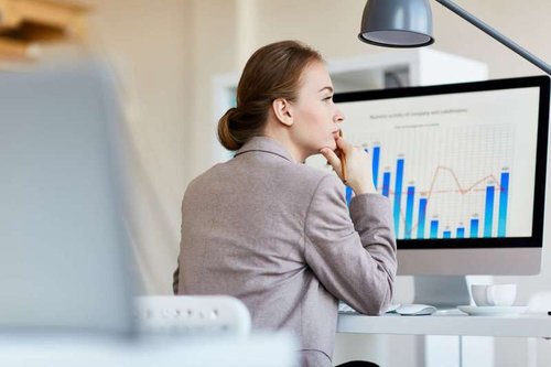 A thoughtful employee analyzing the location's attendance statistics