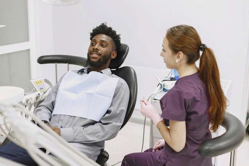 a-black-man-sits-in-a-dental-chair-with-a-pa.max-800x600