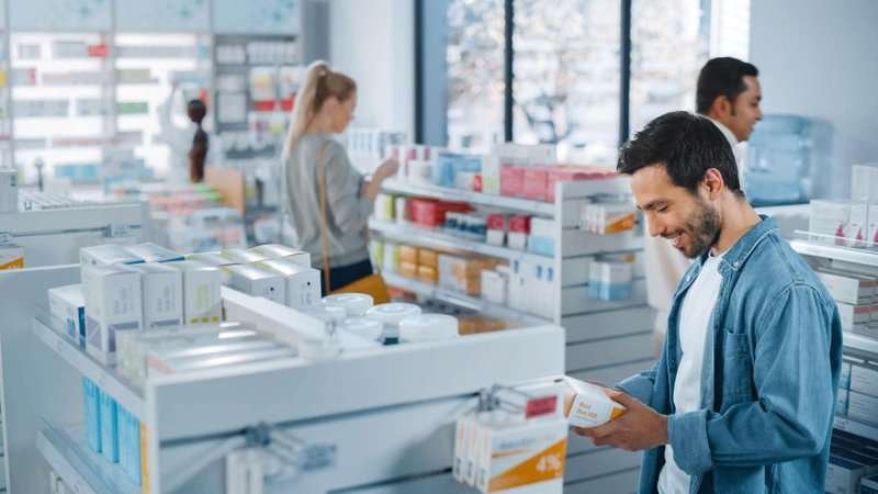a man buys medicine at a pharmacy