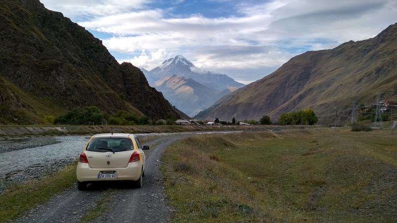 A white car on a mountain road