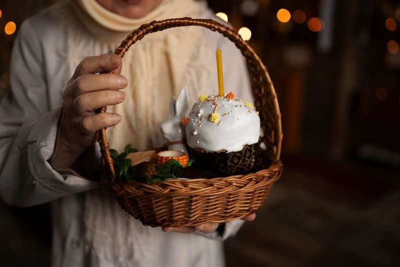 A church candle is placed in the center of the Easter cake.