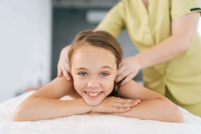 Little smiling girl during a massage session