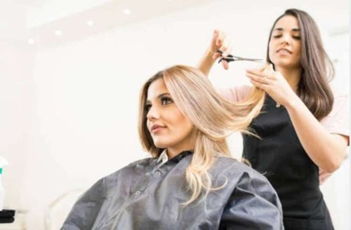 A girl gets a haircut in a beauty salon