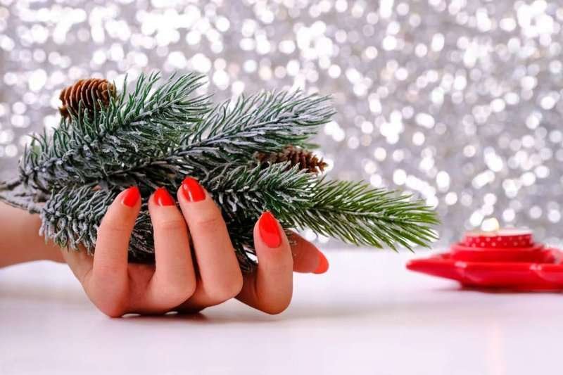 female-hands-there-is-fir-branch-burning-candle-nearby-christmas-decoration