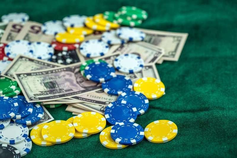 gaming chips and currency on the table