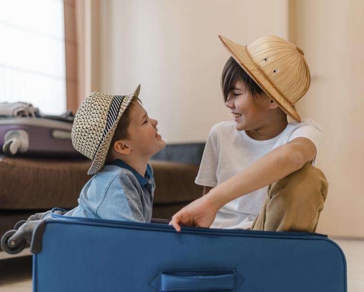 kids sitting luggage