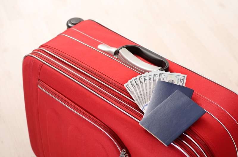 red suitcase passports money