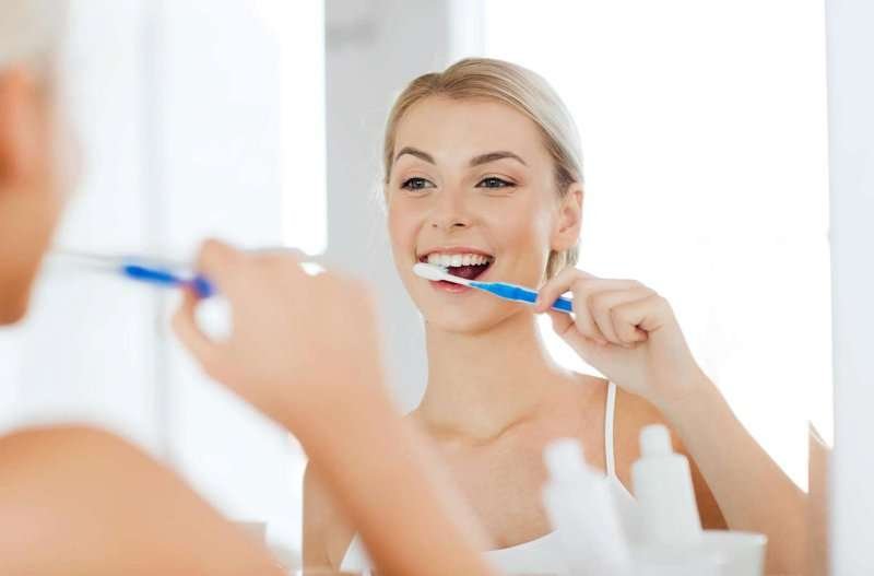 a girl brushing her teeth
