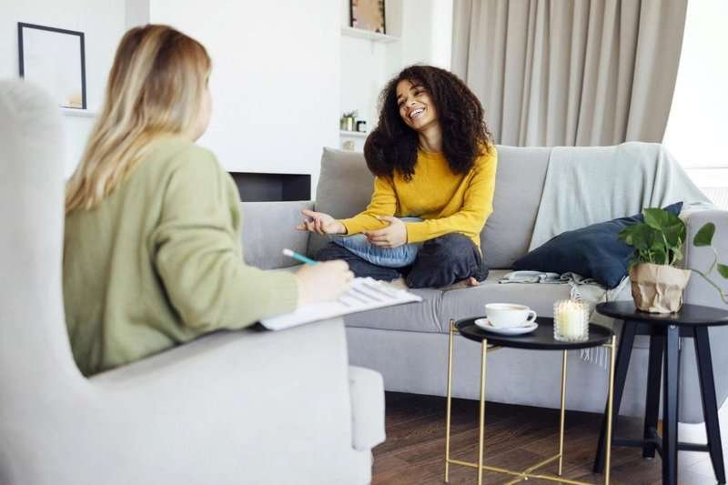 Two girlfriends are talking in a hotel