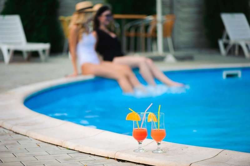 Two women relaxing by the pool