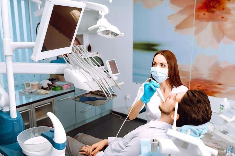 young-man-at-the-dentists-chair-during-a-den.max-800x600
